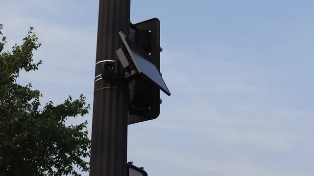 Flock safety police law enforcement license plate reader set up outside to help monitor traffic and catch vehicle speeders.