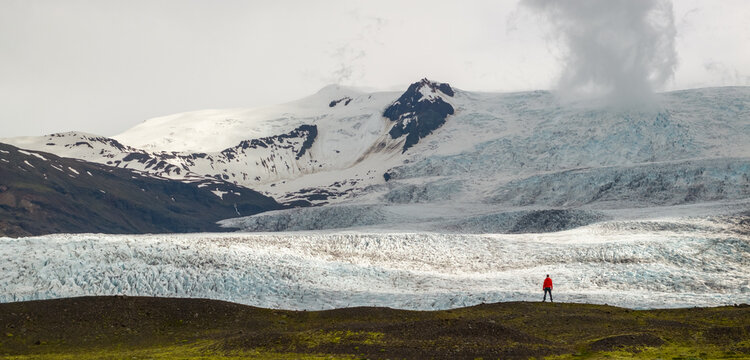 Hiker Overlooking Iceland Glacier and Glacial Lagoon from Above