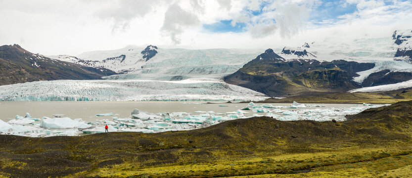 Hiker Overlooking Iceland Glacier and Glacial Lagoon from Above