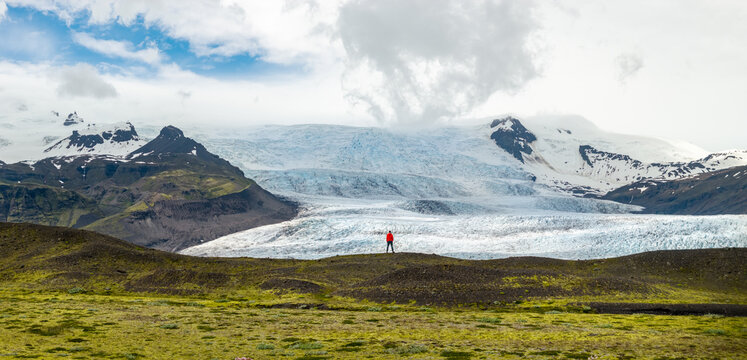 Hiker Overlooking Iceland Glacier and Glacial Lagoon from Above