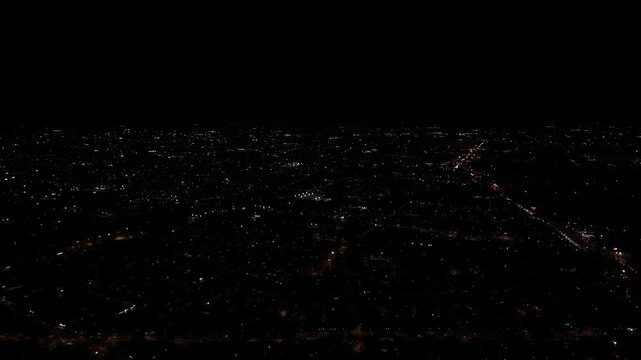 Houses and buildings at night, with the lights on in the Maipu commune, country of Chile
