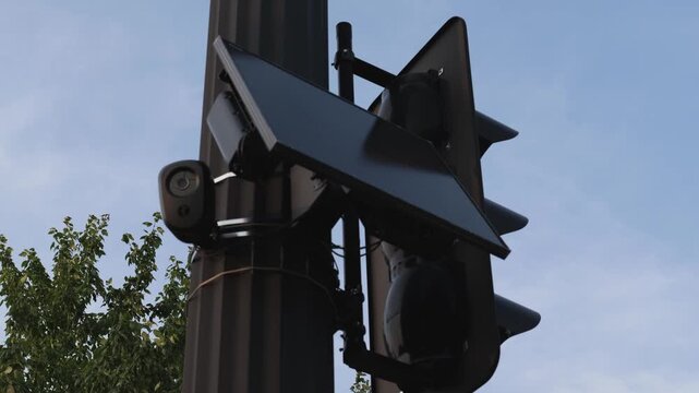 Flock safety police law enforcement license plate reader set up outside to help monitor traffic and catch vehicle speeders.