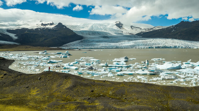 Hiker Overlooking Iceland Glacier and Glacial Lagoon from Above