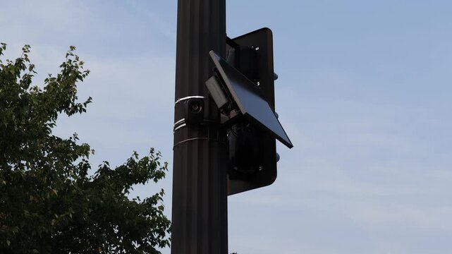 Flock safety police law enforcement license plate reader set up outside to help monitor traffic and catch vehicle speeders.