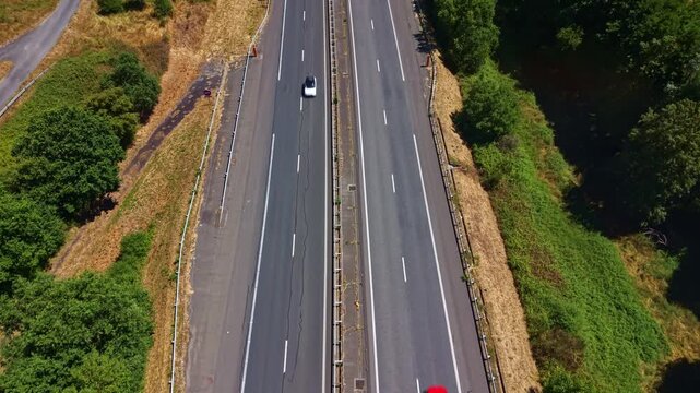 Drone view following traffic along the L'Armoricaine dual carriageway in Chang&eacute;, Mayenne, France.