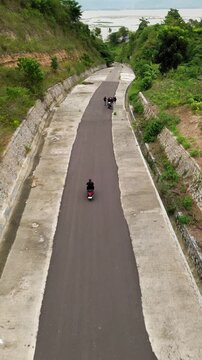 Aerial View of Motorcycle Rider on Rural Road with Greenery