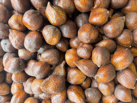 Pile of Salak fruit (Salacca zalacca) in the supermarket, a fruit with a distinctive sweet taste and slightly astringent but crunchy.