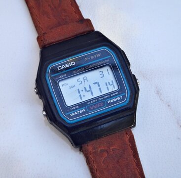 Casio F-91W digital watch on leather strap