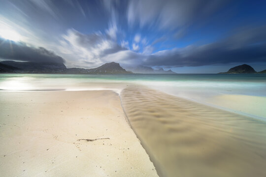 Last sunlight glowing over stream outlet at Haukland Strand Beach