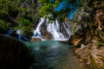 Fototapeta premium The Uçansu waterfall in Gündoğmuş, a district of Antalya that is not well known but worth exploring, is one of the most popular natural wonders of the city. Uçansu waterfall, which is one of the first