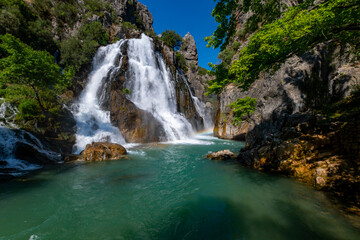 Fototapeta premium The Uçansu waterfall in Gündoğmuş, a district of Antalya that is not well known but worth exploring, is one of the most popular natural wonders of the city. Uçansu waterfall, which is one of the first