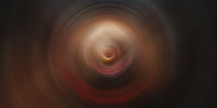 Abstract circular tunnel background with glowing core and radial motion blur.