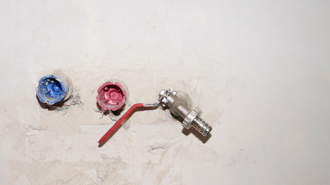 pex pipe outlets and water tap fitting on wall