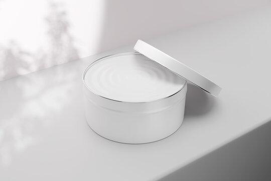 Cosmetic tin jar mockup with open lid leaning on container, blank white round metal box for cream pomade wax or body butter, front view packaging display with leaf shadow background, 3d render