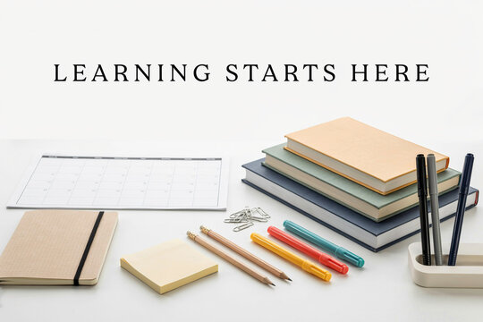 Learning starts here quote with stacked books and colorful pens on white background