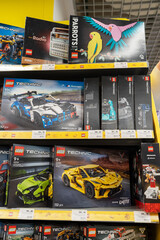 Fototapeta premium Lego products on a shelf in a shop. Boxes of Lego sets displayed on supermarket shelves. Minsk, Belarus - June 10, 2026