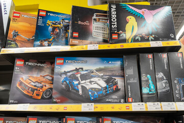 Fototapeta premium Lego products on a shelf in a shop. Boxes of Lego sets displayed on supermarket shelves. Minsk, Belarus - June 10, 2026
