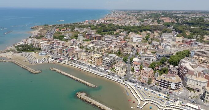 Aerial view of the town of Anzio, located in the province of Rome, in the Lazio region of Italy. There is a beautiful waterfront promenade that runs along the Mediterranean Sea and the city port.