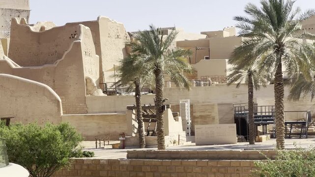DIRIYAH, SAUDI ARABIA - JULY 10, 2026: Historic At-Turaif district showcasing traditional mud-brick Najdi architecture and palm trees in Diriyah.
