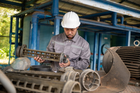 Industrial Maintenance Engineer Checking Pump Impeller for Reliable Plant Operation