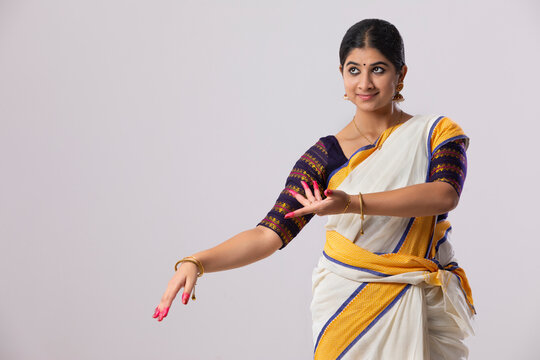 Woman in a South Indian saree practicing (No Suggestions) mudra