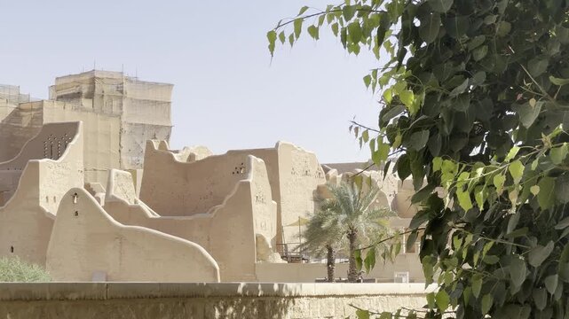 DIRIYAH, SAUDI ARABIA - JULY 10, 2026: Historic At-Turaif district showcasing traditional mud-brick Najdi architecture and palm trees in Diriyah.