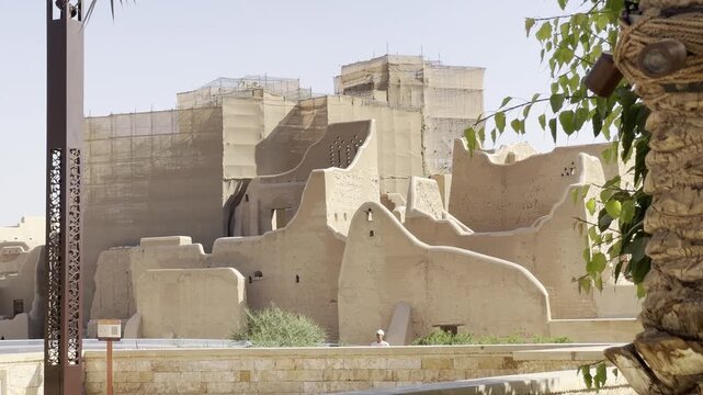 DIRIYAH, SAUDI ARABIA - JULY 10, 2026: Historic At-Turaif district showcasing traditional mud-brick Najdi architecture and palm trees in Diriyah.