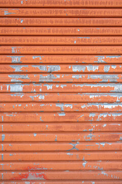 Close-up of old orange metal door