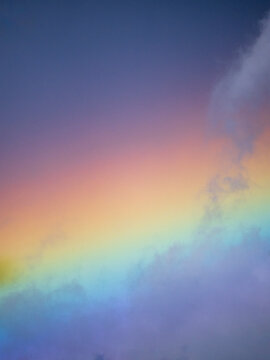 Clouds on rainbow colored sky