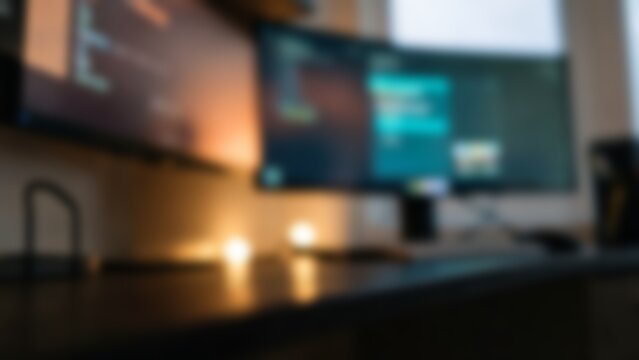 Blurred dual monitor desk setup for modern tech website hero