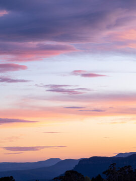 Pink and orange clouds against blue sky