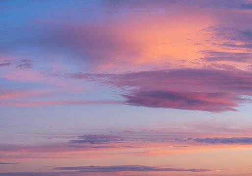 Pink and orange clouds against blue sky