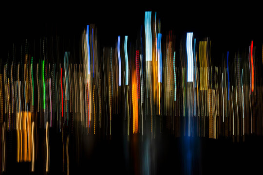 Vertical light trails on dark background