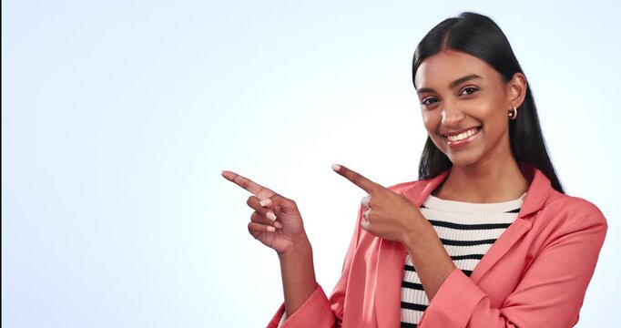 Pointing, mockup and face of woman in studio for marketing, promotion or advertising. Happy, smile and portrait of Indian female model with presentation hand gesture by white background with mock up.