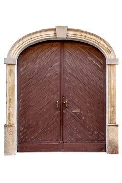 Ancient brown wooden double door with diagonal planks, set in a historic stone arch. Traditional rustic entrance with vintage handles and mailbox slot, showing authentic weathered texture.