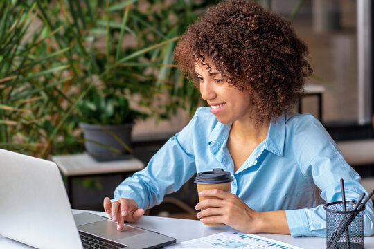 Businesswoman Working On Laptop With Coffee Cup