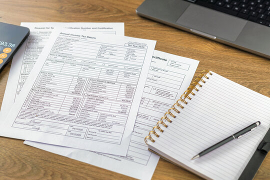 Annual tax return forms with open notebook