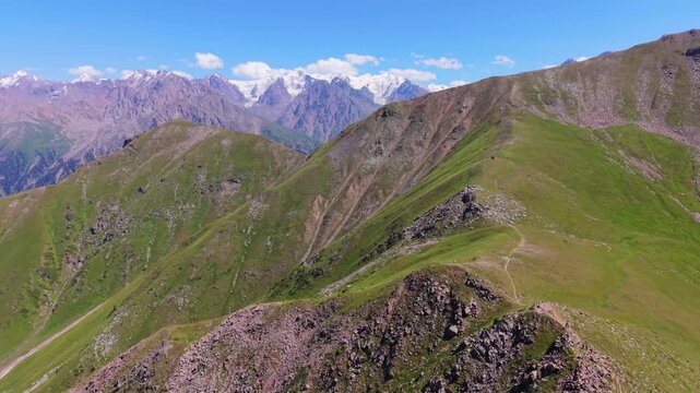 Drone flying backwards away from mountain peaks in Almaty Kazakhstan