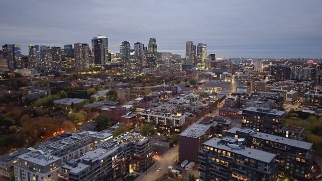 Aerial night skyline of Montreal with Lachine Canal, illuminated bridge, downtown skyscrapers and city lights in Quebec, Canada. g.