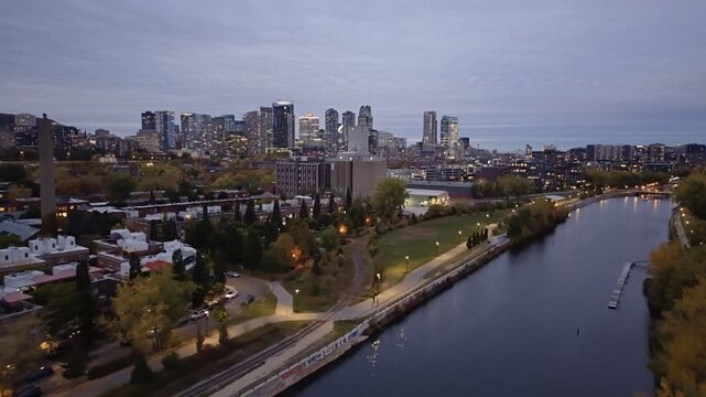 Aerial night skyline of Montreal with Lachine Canal, illuminated bridge, downtown skyscrapers and city lights in Quebec, Canada. g.