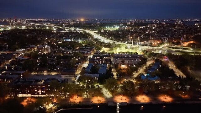 Aerial night skyline of Montreal with Lachine Canal, illuminated bridge, downtown skyscrapers and city lights in Quebec, Canada. g.