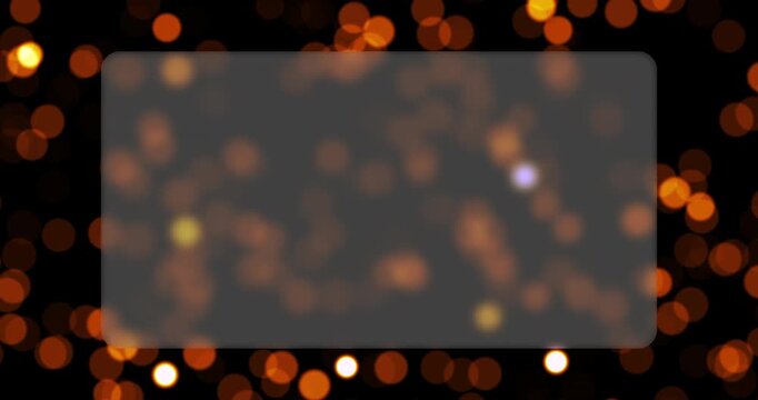 Warm bokeh lights float around a clear glass frame in a continuous seamless loop animation. Sparkling particles illuminate the dark background to enhance titles and logos.