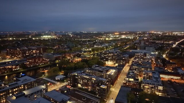Aerial night skyline of Montreal with Lachine Canal, illuminated bridge, downtown skyscrapers and city lights in Quebec, Canada. g.