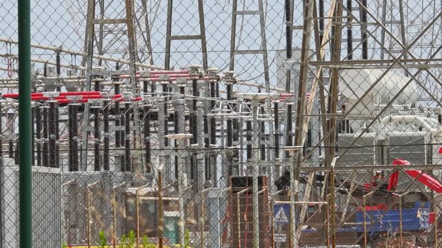 High-voltage electrical substation, through a layer of air shimmering at high temperatures. Increased energy consumption of air conditioners during El NiNO heat waves