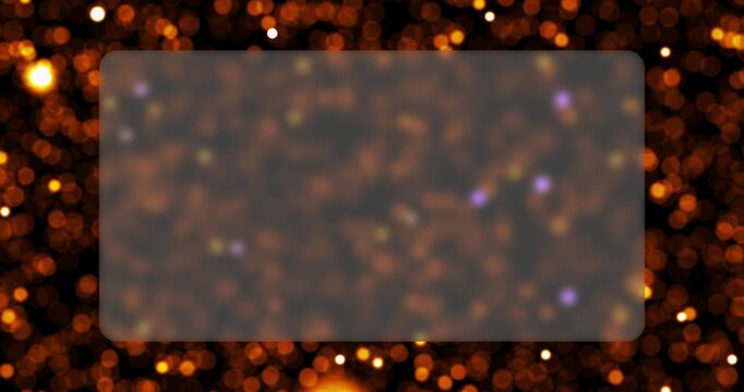 Glowing golden bokeh particles float around a frosted glass plate in a seamless loop. This elegant abstract motion background provides a perfect frame for text or graphics.