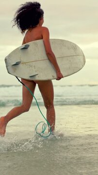 Back, woman and running at beach with surfboard, travel and adventure for summer holiday. Female person, surfer and waves at sea for surfing, getaway journey and water activity for tropical vacation