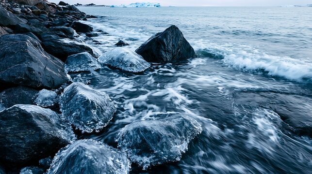Frozen Coastline with Waves and Ice Covered Rocks along the Shore