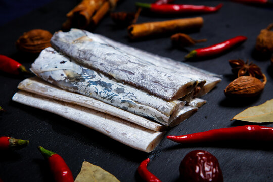 Raw Silver Hairtail Fish Segments With Cooking Spices On Slate