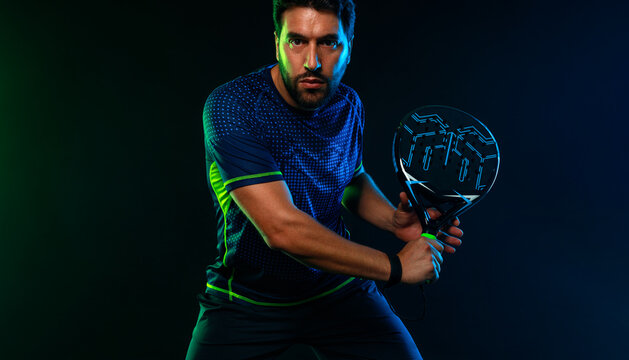Padel Tennis Player with Racket in Hand. Paddle tenis, on a blue background. Download in high resolution.