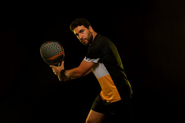 Fototapeta premium Padel Tennis Player with Racket in Hand. Paddle tenis, on a blue background. Download in high resolution.